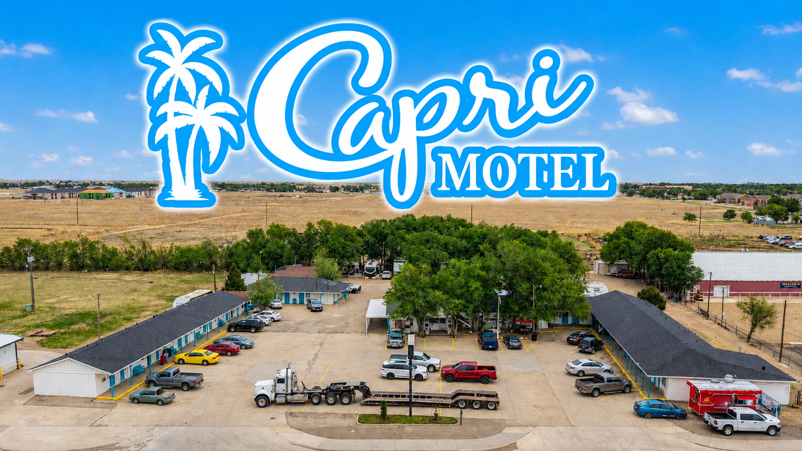 Aerial daytime view of the Capri Motel property