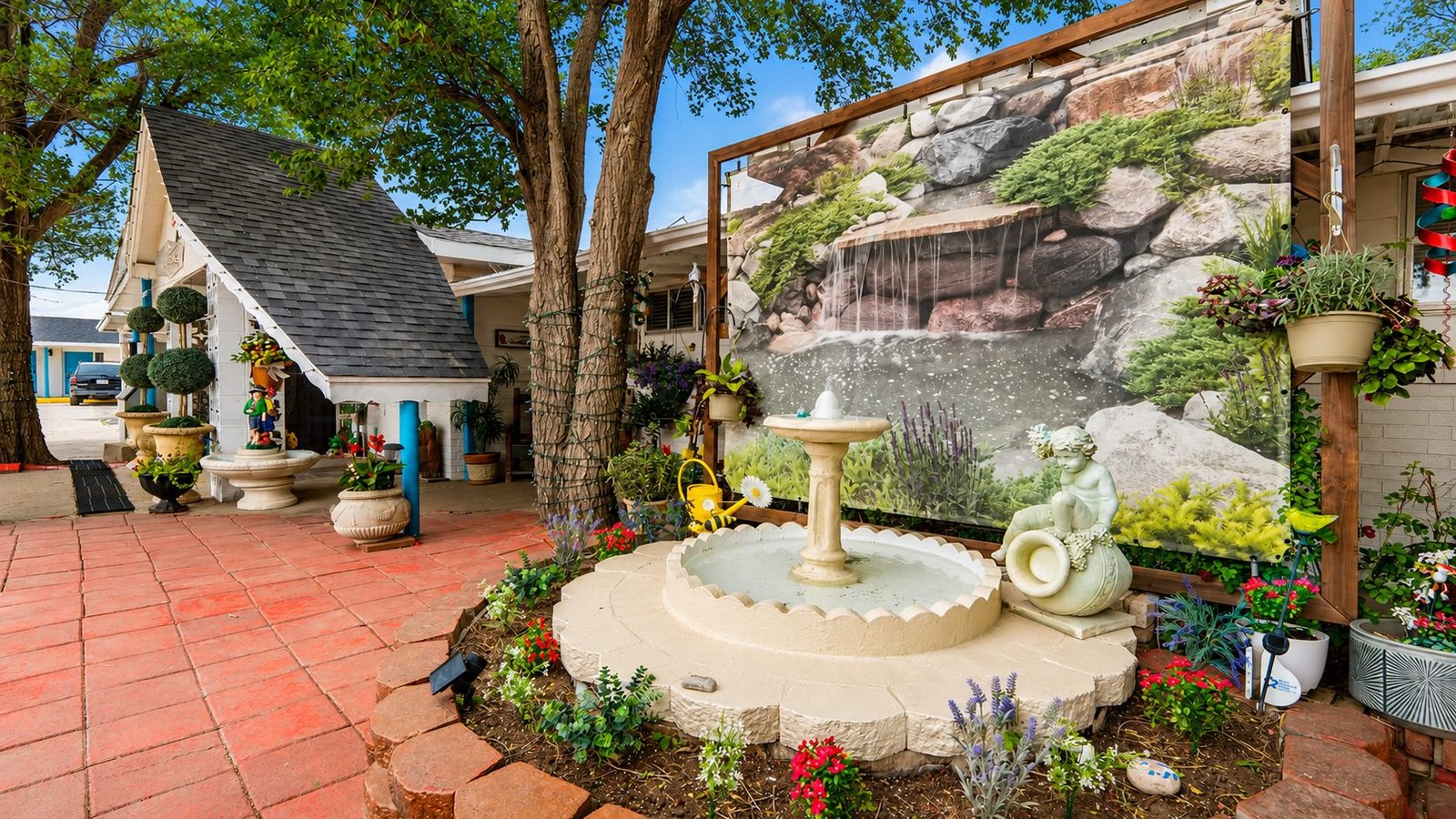Garden fountain and colorful patio near the Capri Motel office