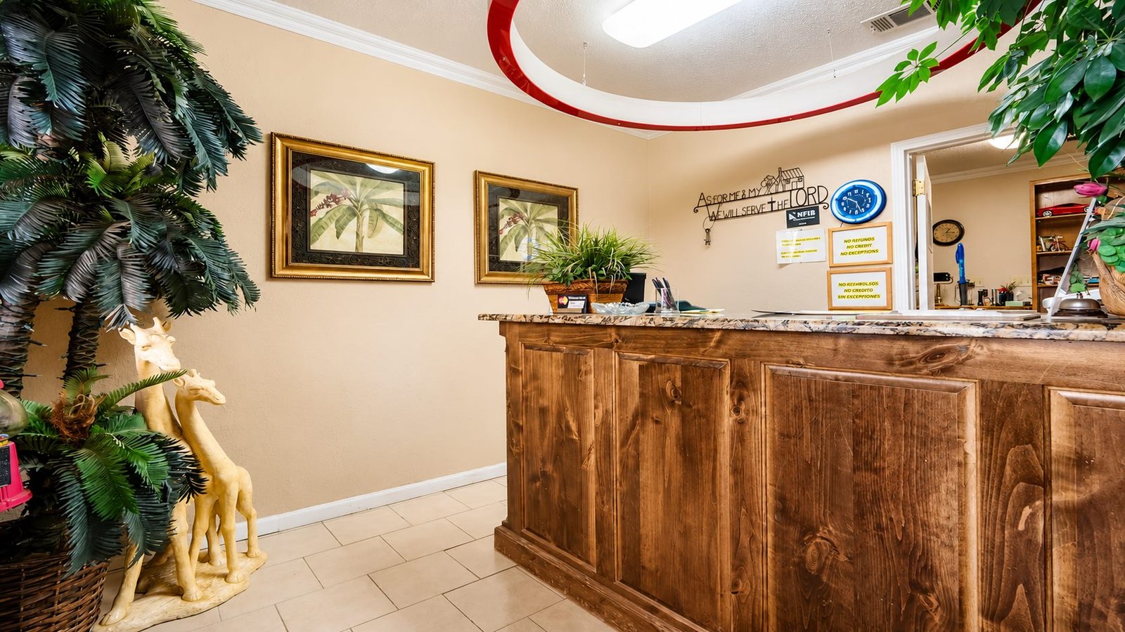 Warm wood front desk inside the Capri Motel office