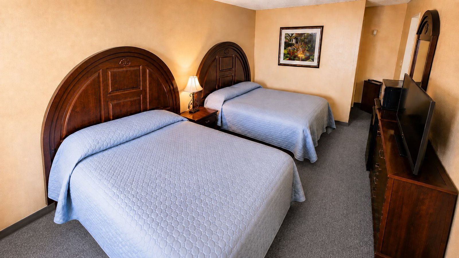 A Capri Motel double room with two neatly made beds