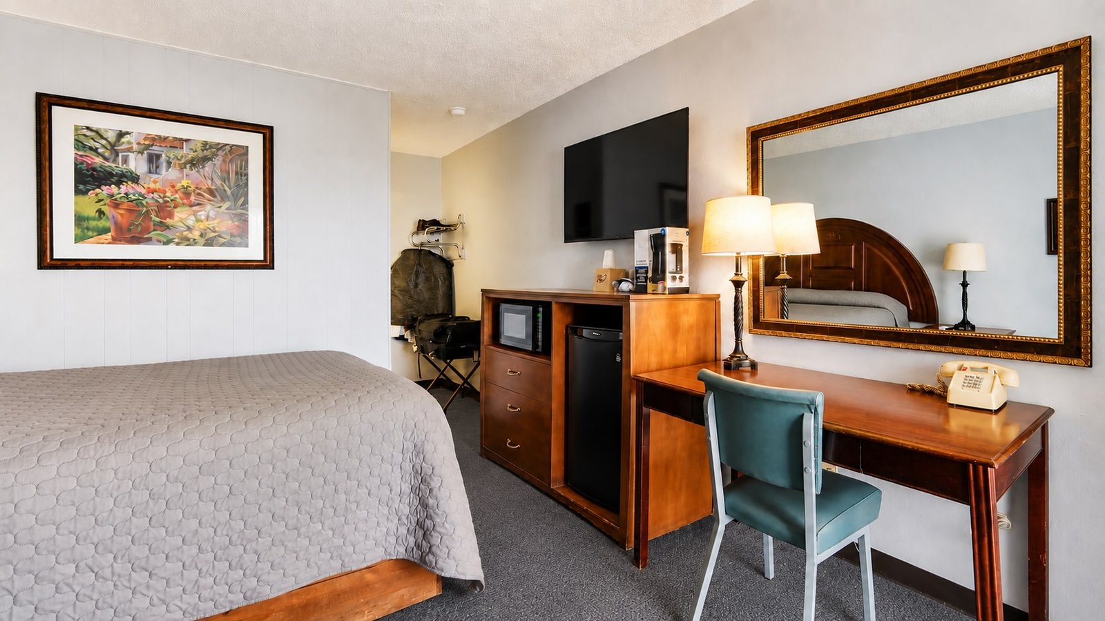 Desk and furnishings inside a Capri Motel single room
